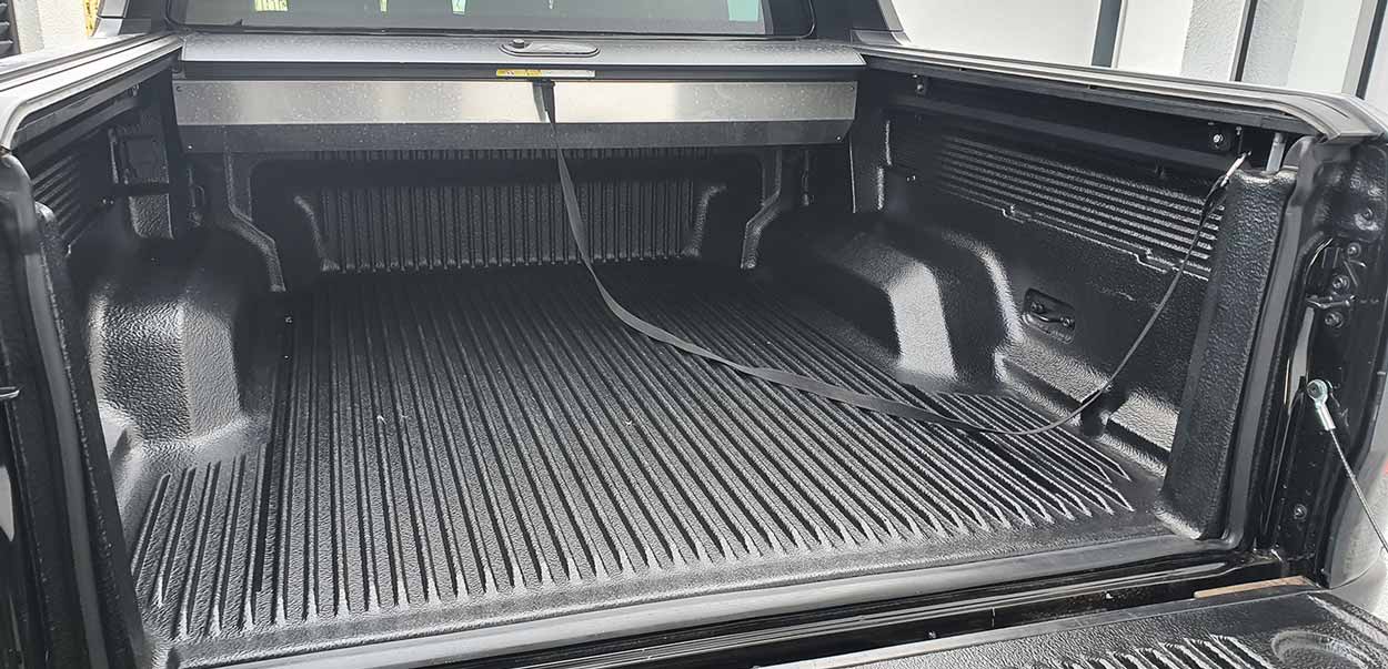 Spray-in bedliner installation at Phil Long Collision Center Colorado Springs